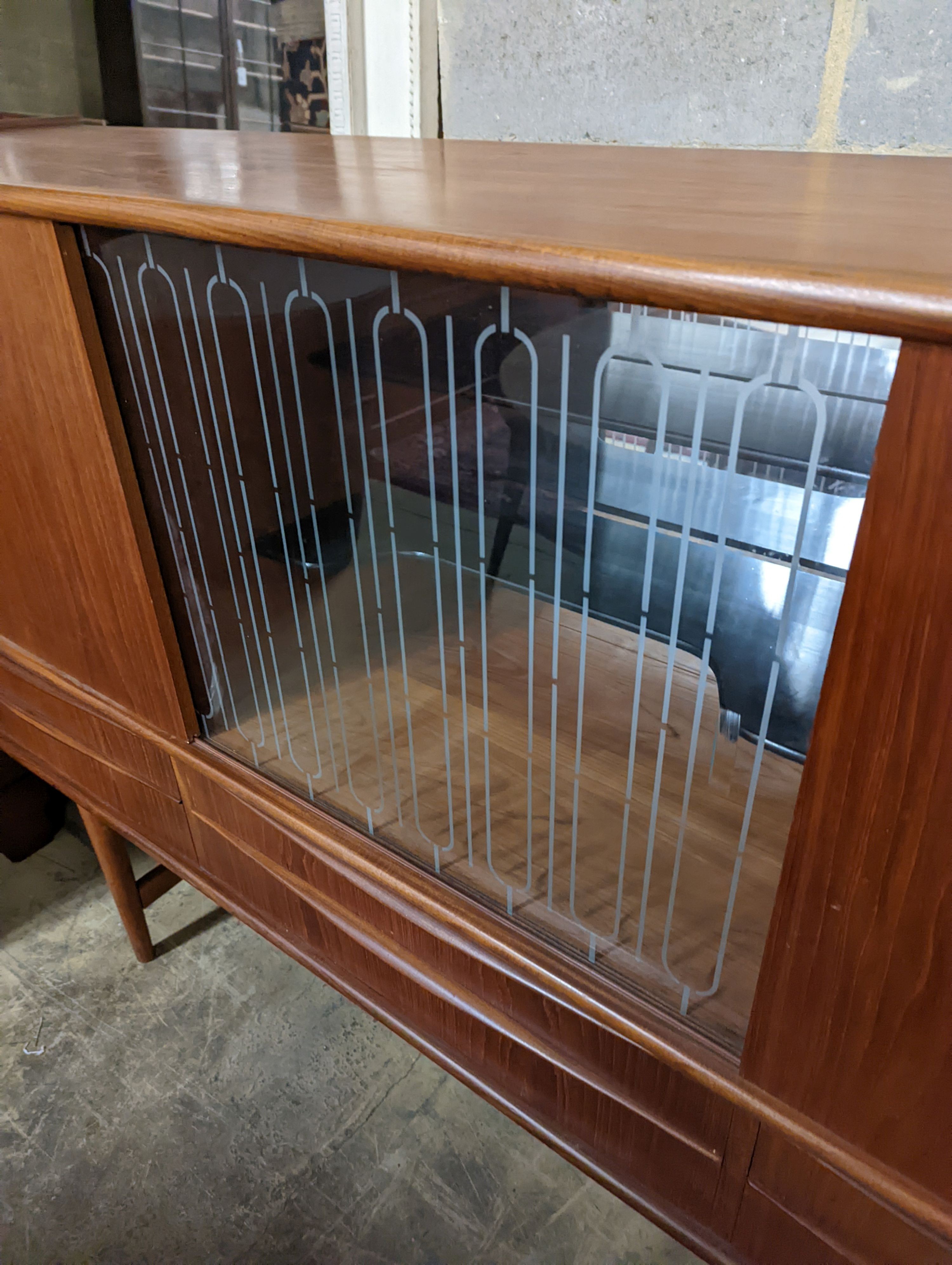 A mid century Danish teak sideboard, length 184cm, depth 44cm, height 115cm